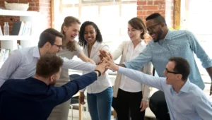 people putting their hands together in a group signifying unity