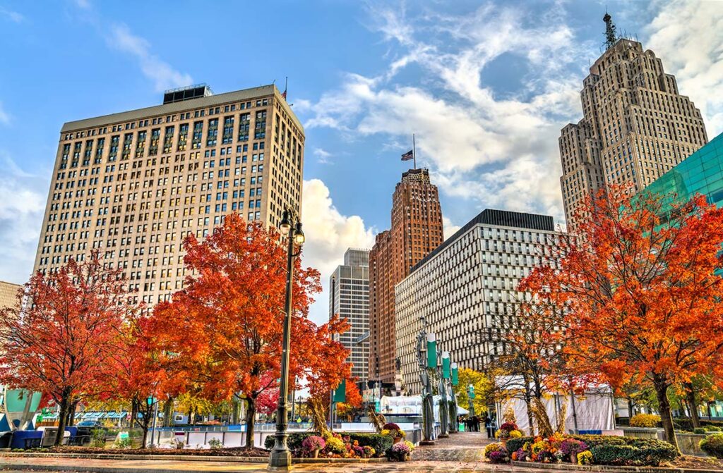 Historic buildings in Downtown Detroit, Michigan on a bright, clear Fall day with a blue sky and fluffy clouds.