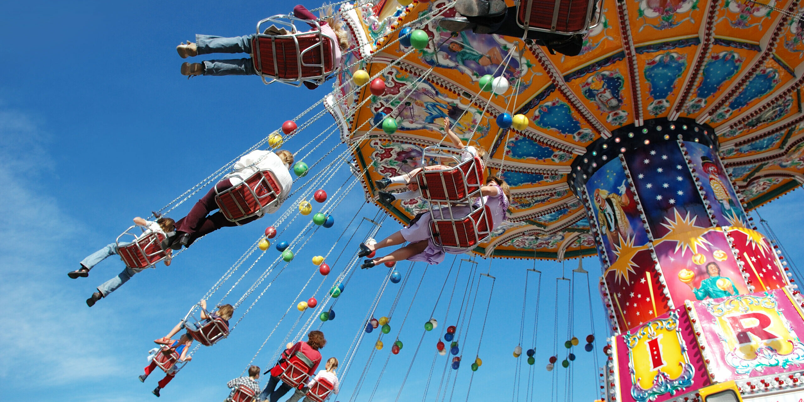 Families at the fair on a swing ride